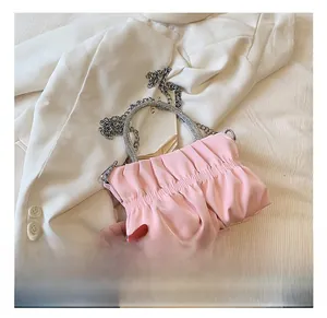 Close-up of pink cloud bag with rhinestone handle and silver metal chain detail