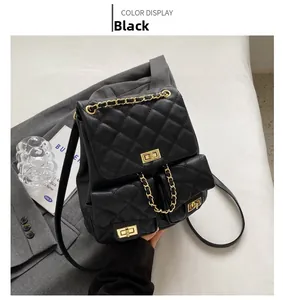 Detail of black quilted leather backpack with dual pockets and gold chain handle