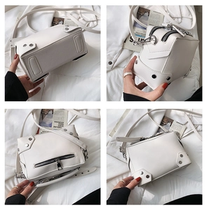 Detail view of white rivet crossbody bag with silver hardware and lychee grain leather