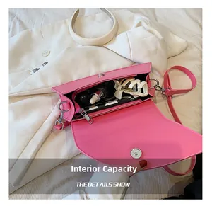Internal capacity of pink saddle bag showing zipper pocket and daily essentials