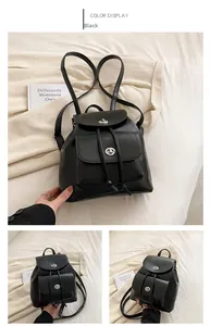 Detail view of black drawstring backpack with matte finish and silver twist-lock closure