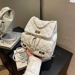 White quilted faux leather backpack with gold chain handle and metal twist-lock closures