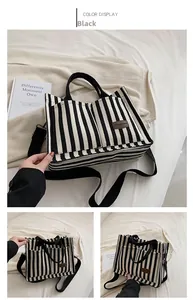 Detail view of black and white striped canvas tote with brown leather fashion label