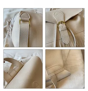 Détail du sac à dos crème texture lychee avec pompon et boucles métalliques dorées