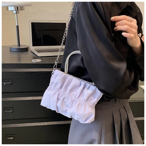 Detail showing lavender pleated cloud bag with rhinestone handle and silver metal chain