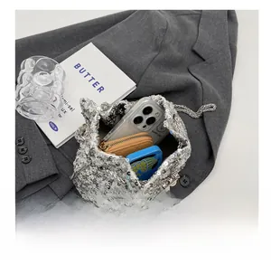 Internal view of silver sequin bucket bag showing phone and wallet storage capacity