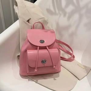 Pink PU leather backpack with silver turnlock closure and drawstring in a minimalist style