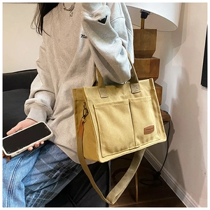 Canvas tote bag with front dual pockets and adjustable shoulder strap in olive green