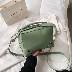 Retro light green box crossbody bag with silver rivet details and textured leather