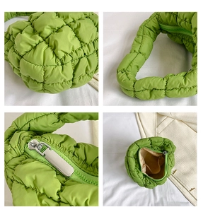 Detail view of light green quilted puff handbag showing texture, zipper and inner lining