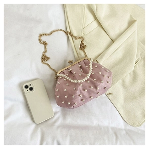 Détail du sac à main plissé rose clair avec perles élégantes et fermoir en métal doré