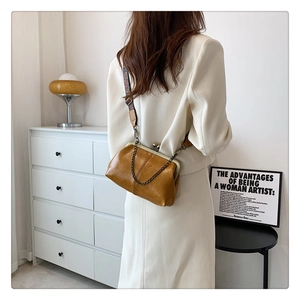 Retro mustard yellow doctor bag with bohemian strap and metallic clasp closure detail