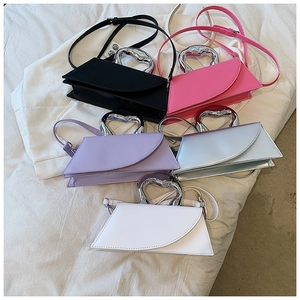 Collection of chic handbags in five colors featuring unique silver heart-shaped metal handles