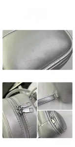 Detail of silver textured mini backpack featuring dual zippers and reinforced stitching
