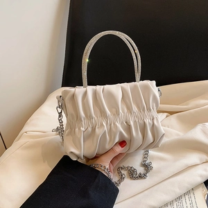 White pleated cloud bag with sparkling rhinestone ring handle and silver chain strap
