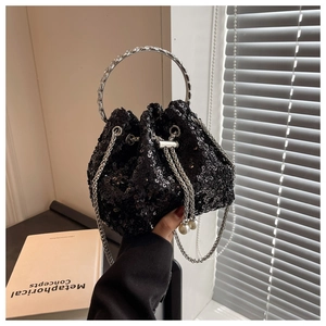 Detail of black sequined bucket bag with rhinestone ring handle and pearl drawstring