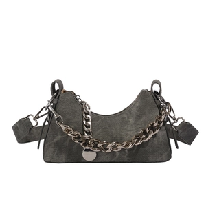 Sac hobo croissant en denim gris foncé avec chaîne argentée sur fond blanc