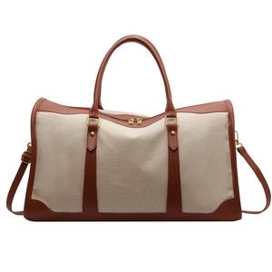 Minimalist beige canvas tote bag with brown leather trim and adjustable shoulder strap