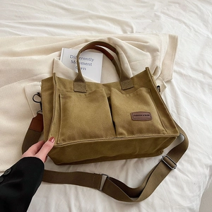 Olive green canvas tote bag with multi-pockets and adjustable shoulder strap