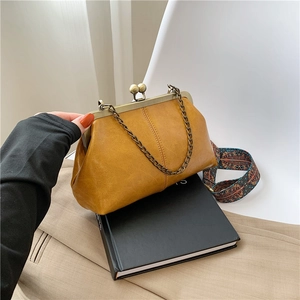 Vintage yellow leather shell bag with gold chain and ethnic pattern shoulder strap