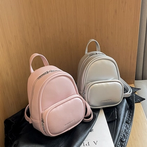 Mini fashion backpacks in pink and silver leather featuring a round front zipper pocket