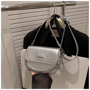 Detail of silver metallic crossbody bag with chunky chain strap and adjustable belt