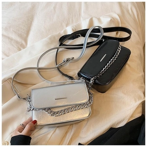 Detail of vintage-style crossbody bags with wrinkled leather texture and metal chain