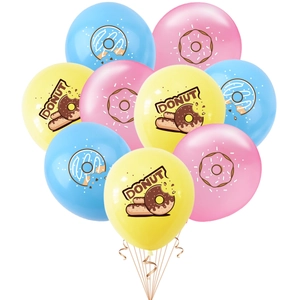 Close-up of pastel latex balloons with colorful donut illustrations and champagne ribbons
