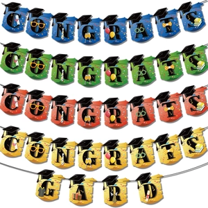 Close-up of multicolored congrats and grad banners with doctoral cap and diploma details