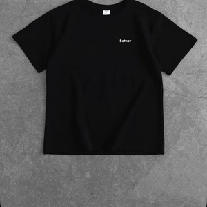 Minimalist black Y2K cotton t-shirt with Setner logo print on gray concrete background