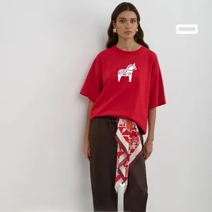 Detail of red cotton T-shirt featuring a white horse print with stylish floral scarf accent