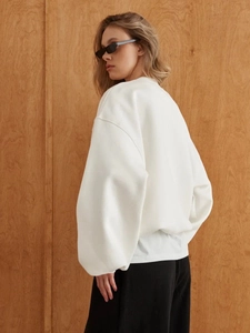 Detail of white oversized crewneck sweatshirt featuring premium thick cotton fabric