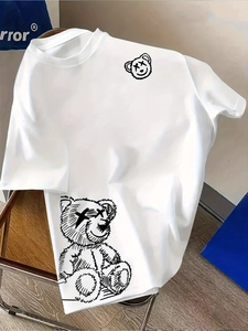 Detail of white cotton T-shirt featuring hand-drawn bear graphic and round neckline