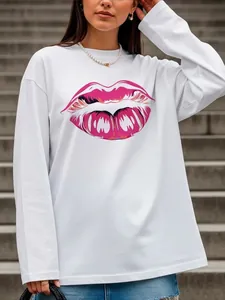 Detail of loose white cotton long sleeve t-shirt with pink lip graphic and accessories