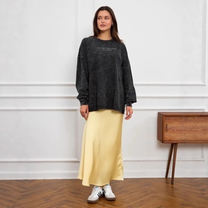 Vintage washed black oversized long sleeve sweatshirt with printed text and yellow satin skirt