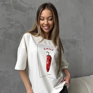 Detailed close-up of a white cotton t-shirt with a chili graphic and chic text print