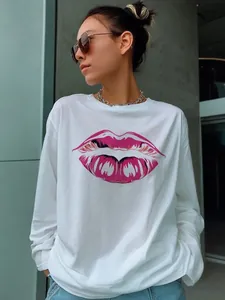 Detail of artistic pink lip print on white cotton long sleeve loose casual t-shirt