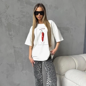 Detail of white cotton t-shirt with chili print and Just Chilling text on a model