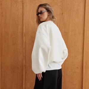 Minimalist oversized white crewneck sweatshirt in a thick cotton fleece street style