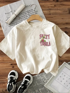 Flat lay of cream cotton t-shirt with Salty Tequila graphic on wooden background