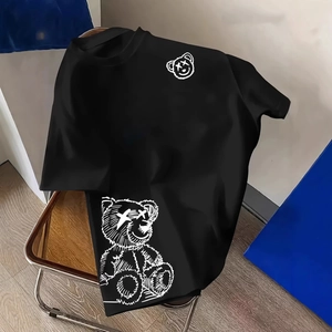 Men's black crewneck T-shirt with white line art bear prints on a minimalist metal chair