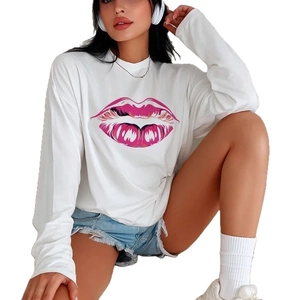 Loose white cotton long sleeve T-shirt with pink lip print paired with denim shorts