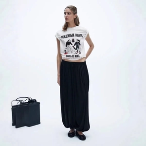 Chic loose white cotton T-shirt with vintage print and black wide-leg trousers