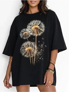 Detail view of golden dandelion print and star dust patterns on black cotton T-shirt