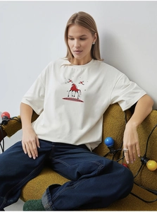 Detail of white cotton T-shirt featuring vintage ethnic horse and bird illustration