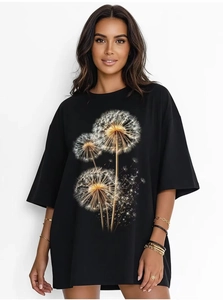 Macro detail of artistic dandelion seed prints on a black oversized cotton t-shirt