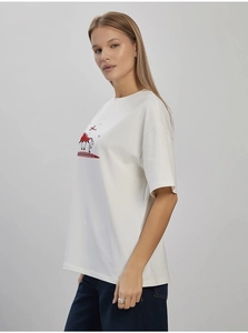 Detailed view of white cotton T-shirt featuring abstract red and black print on the front