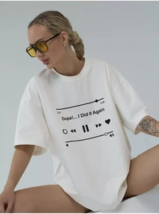 Detail of the oversized white cotton T-shirt featuring a black music player graphic print