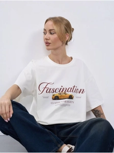 Close-up of white cotton T-shirt featuring vintage yellow sports car graphic print