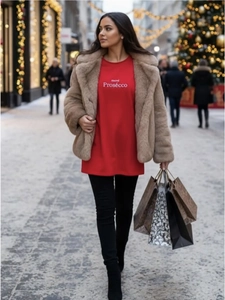 Street style shot of red Hotel Prosecco cotton tee paired with a tan faux fur jacket